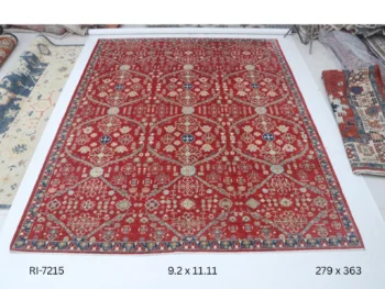 Handmade wool and cotton area rug or runner with classic floral Heriz pattern displayed on floor