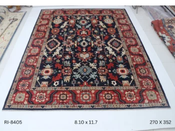 Handmade wool and cotton area rug or runner with classic floral Heriz pattern displayed on floor