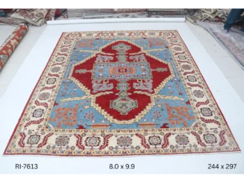 Handmade wool and cotton area rug or runner with classic floral Heriz pattern displayed on floor