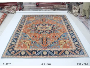 Handmade wool and cotton area rug or runner with classic floral Heriz pattern displayed on floor