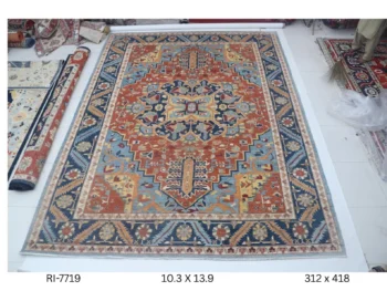 Handmade wool and cotton area rug or runner with classic floral Heriz pattern displayed on floor