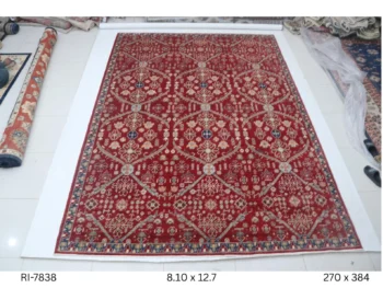Handmade wool and cotton area rug or runner with classic floral Heriz pattern displayed on floor