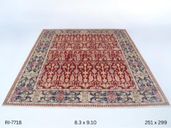 Handmade wool and cotton area rug or runner with classic floral Heriz pattern displayed on floor