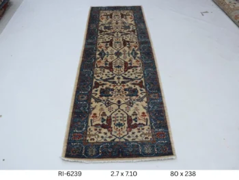 Handmade wool and cotton area rug or runner with classic floral Heriz pattern displayed on floor
