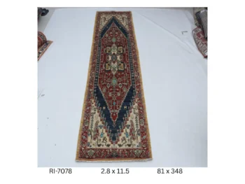 Handmade wool and cotton area rug or runner with classic floral Heriz pattern displayed on floor