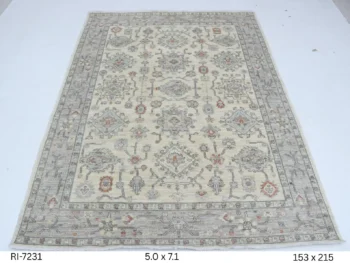 Handmade wool and cotton area rug or runner with classic floral Heriz pattern displayed on floor