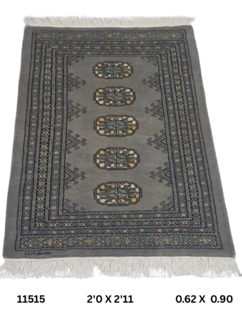 Handmade wool and cotton area rug or runner with repeated geometric Bokhara pattern displayed on floor