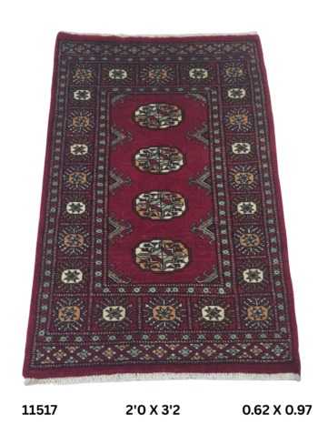Handmade wool and cotton area rug or runner with repeated geometric Bokhara pattern displayed on floor