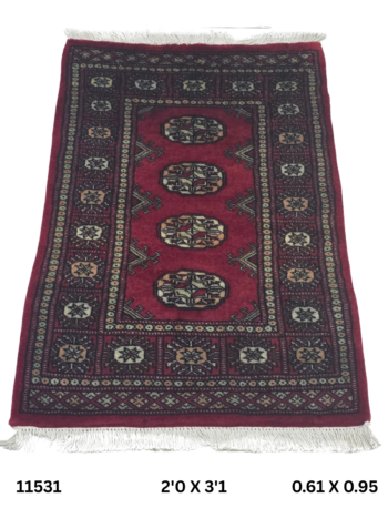 Handmade wool and cotton area rug or runner with repeated geometric Bokhara pattern displayed on floor