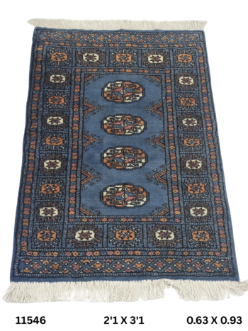 Handmade wool and cotton area rug or runner with repeated geometric Bokhara pattern displayed on floor