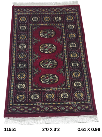 Handmade wool and cotton area rug or runner with repeated geometric Bokhara pattern displayed on floor