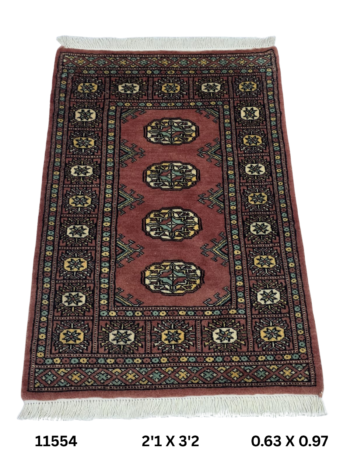 Handmade wool and cotton area rug or runner with repeated geometric Bokhara pattern displayed on floor