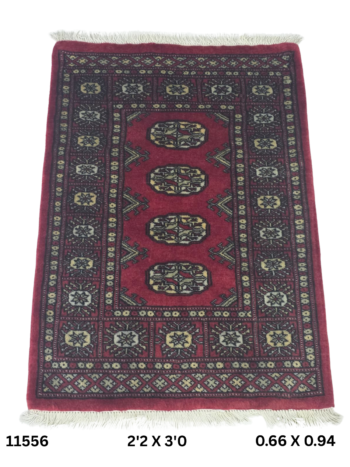 Handmade wool and cotton area rug or runner with repeated geometric Bokhara pattern displayed on floor