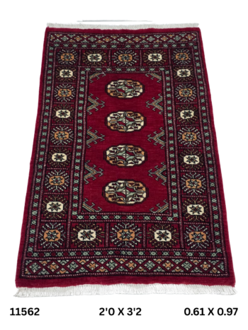 Handmade wool and cotton area rug or runner with repeated geometric Bokhara pattern displayed on floor