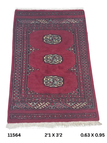 Handmade wool and cotton area rug or runner with repeated geometric Bokhara pattern displayed on floor