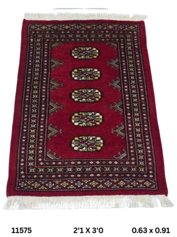 Handmade wool and cotton area rug or runner with repeated geometric Bokhara pattern displayed on floor