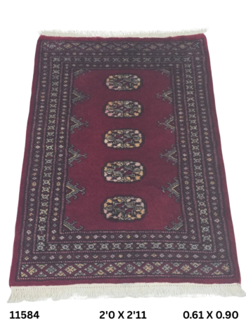 Handmade wool and cotton area rug or runner with repeated geometric Bokhara pattern displayed on floor