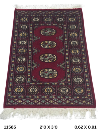 Handmade wool and cotton area rug or runner with repeated geometric Bokhara pattern displayed on floor