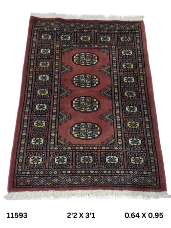 Handmade wool and cotton area rug or runner with repeated geometric Bokhara pattern displayed on floor