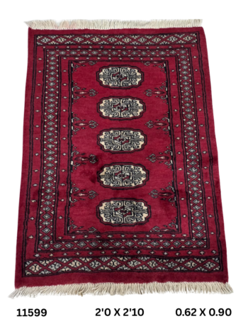 Handmade wool and cotton area rug or runner with repeated geometric Bokhara pattern displayed on floor