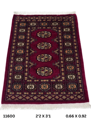 Handmade wool and cotton area rug or runner with repeated geometric Bokhara pattern displayed on floor