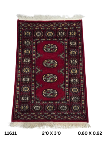 Handmade wool and cotton area rug or runner with repeated geometric Bokhara pattern displayed on floor