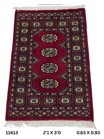 Handmade wool and cotton area rug or runner with repeated geometric Bokhara pattern displayed on floor