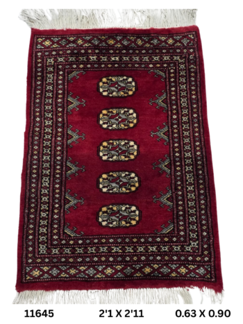 Handmade wool and cotton area rug or runner with repeated geometric Bokhara pattern displayed on floor