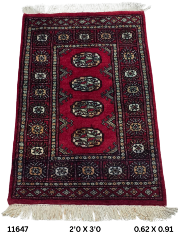Handmade wool and cotton area rug or runner with repeated geometric Bokhara pattern displayed on floor