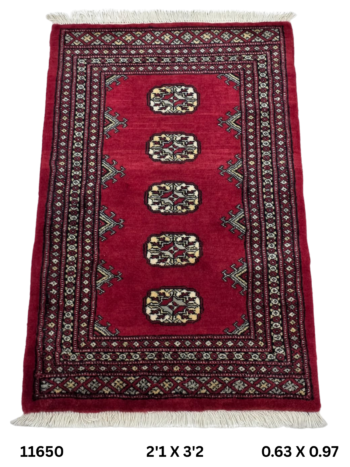 Handmade wool and cotton area rug or runner with repeated geometric Bokhara pattern displayed on floor