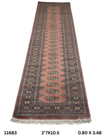 Handmade wool and cotton area rug or runner with repeated geometric Bokhara pattern displayed on floor