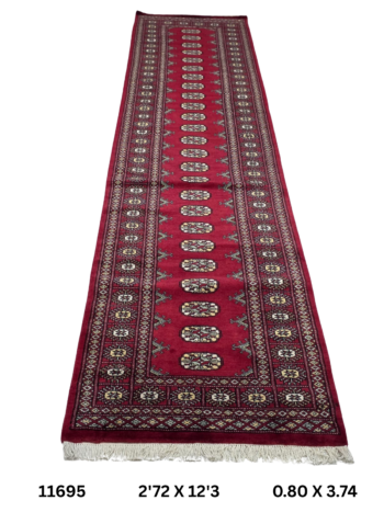 Handmade wool and cotton area rug or runner with repeated geometric Bokhara pattern displayed on floor
