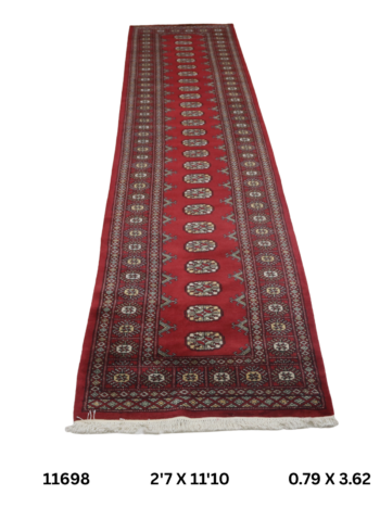 Handmade wool and cotton area rug or runner with repeated geometric Bokhara pattern displayed on floor