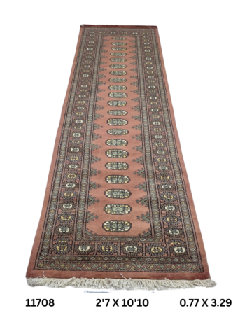 Handmade wool and cotton area rug or runner with repeated geometric Bokhara pattern displayed on floor