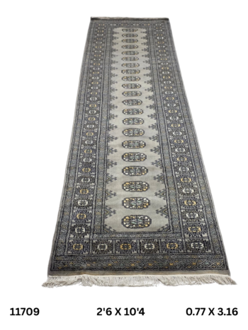 Handmade wool and cotton area rug or runner with repeated geometric Bokhara pattern displayed on floor