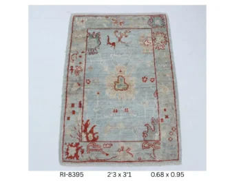Handmade wool and cotton area rug or runner with classic floral Heriz pattern displayed on floor
