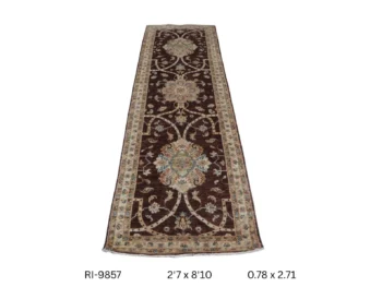 Handmade wool and cotton area rug or runner with classic floral Heriz pattern displayed on floor