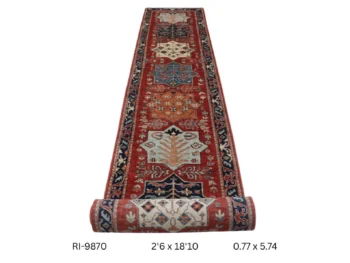 Handmade wool and cotton area rug or runner with classic floral Heriz pattern displayed on floor
