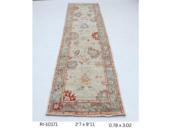 Handmade wool and cotton area rug or runner with classic floral Heriz pattern displayed on floor