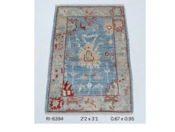 Handmade wool and cotton area rug or runner with classic floral Heriz pattern displayed on floor